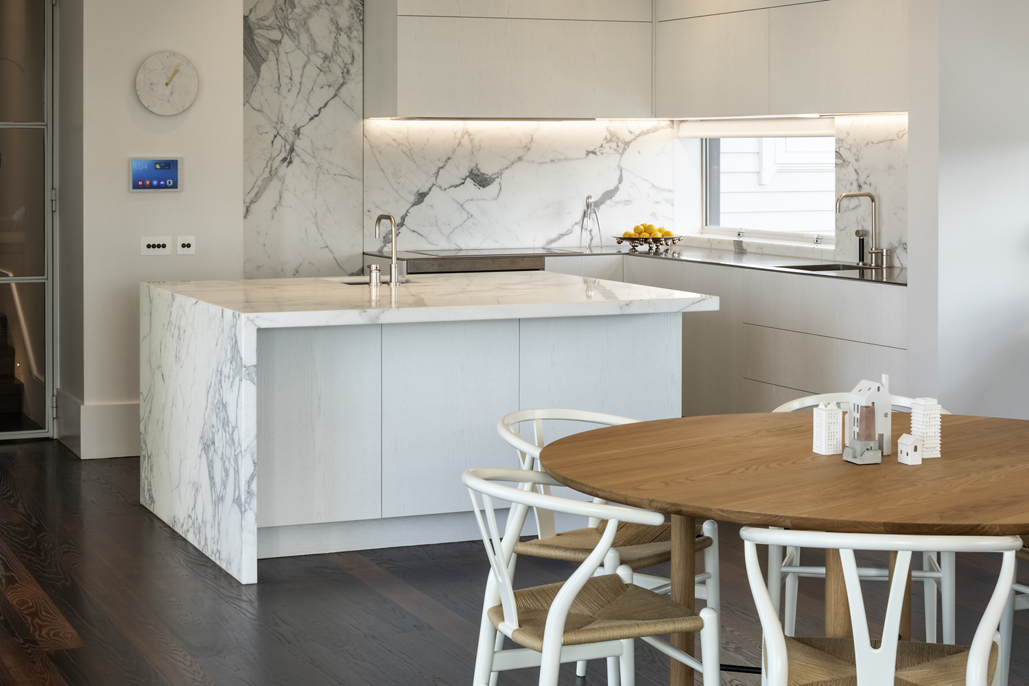 white marble kitchen showcase with wooden dining set